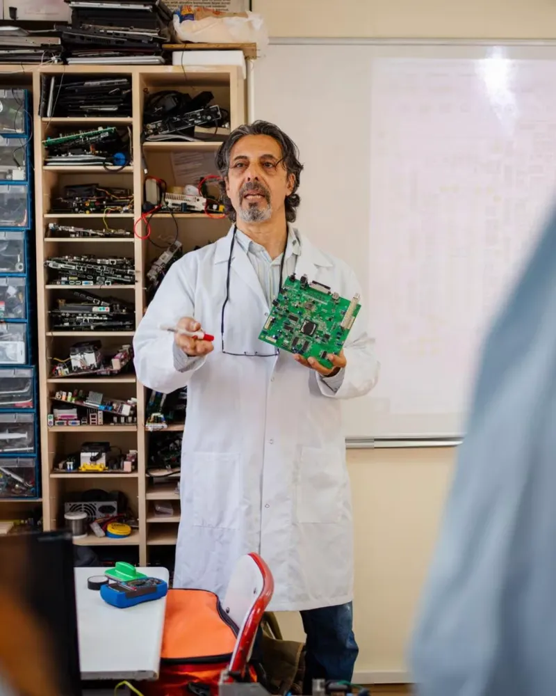 Students performing CAN Bus communication experiments on embedded systems kits